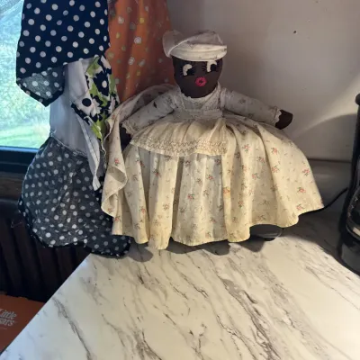 Sale Photo Thumbnail #38: Vintage handmade Topsy-Turvy rag doll in a floral full skirt dress and bonnet, resting on a kitchen counter.