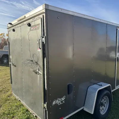 Sale Photo Thumbnail #134: Pace American Outback DLX enclosed cargo trailer featuring double rear doors, a side access door, and a diamond-plate fender.