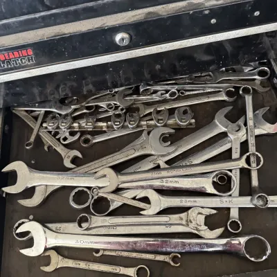 Sale Photo Thumbnail #77: Open tool chest drawer filled with various metal combination and open-end wrenches, including S-K and Craftsman brands.
