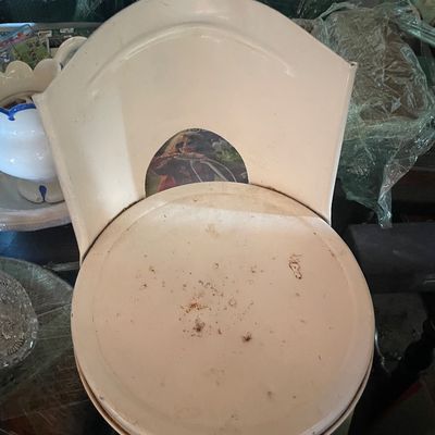 Sale Photo Thumbnail #199: Vintage white painted metal chair featuring a curved backrest with a center cutout, showing visible surface dirt and wear.