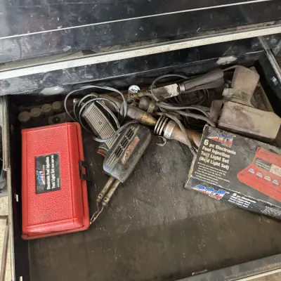 Sale Photo Thumbnail #89: Tool chest drawer containing automotive testing equipment, including an ATD electronic fuel injection test light set, vintage soldering guns, and various hand tools.
