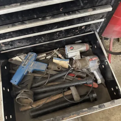 Sale Photo Thumbnail #74: Open toolbox drawer filled with various automotive tools, including a blue timing light, pneumatic impact wrenches, sockets, and hand tools.