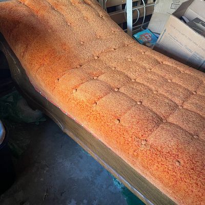 Sale Photo Thumbnail #183: Vintage mid-century contoured chaise lounge upholstered in textured orange tufted fabric with a wooden base.