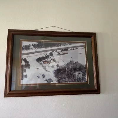 Sale Photo Thumbnail #47: Framed aerial photograph of a snowy rural farmstead, double-matted in a dark wood frame.