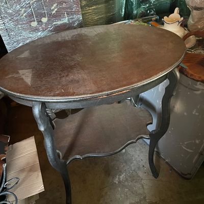 Sale Photo Thumbnail #189: Vintage dark wood oval accent table featuring cabriole legs and a lower tier shelf with a scalloped edge.