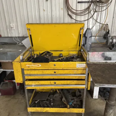 Sale Photo Thumbnail #68: Yellow Blue-Point rolling tool cart with three drawers, top storage area, and bottom shelf containing various tools and hardware.