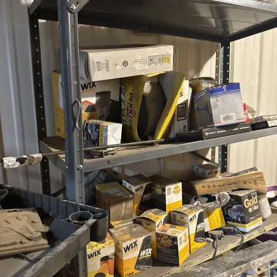 Sale Photo Thumbnail #54: Metal garage shelving unit holding various boxed automotive supplies, including WIX and Pennzoil oil and air filters.