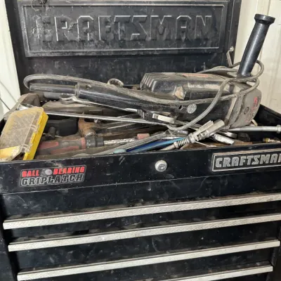 Sale Photo Thumbnail #83: Black Craftsman Griplatch tool chest filled with assorted hand tools, wrenches, and a power tool.