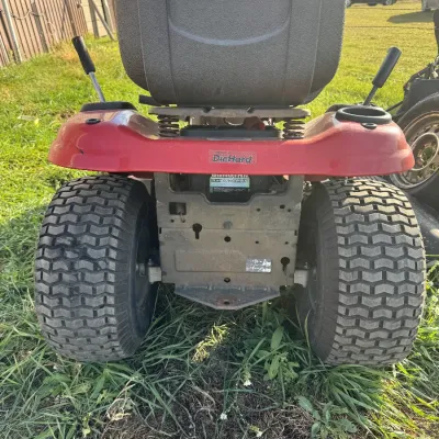 Sale Photo Thumbnail #138: Rear view of a red Craftsman riding lawn mower featuring a high-back seat and a DieHard battery installation.