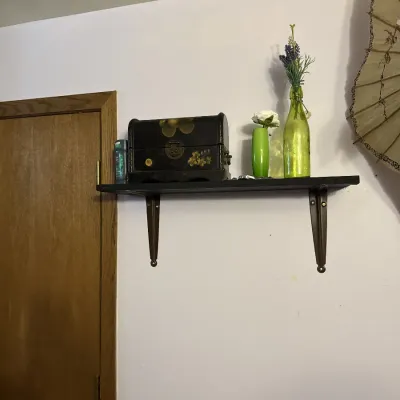Sale Photo Thumbnail #9: Wall-mounted shelf displaying decorative items including a hand-painted floral treasure chest box and green glass bottles with faux flowers.