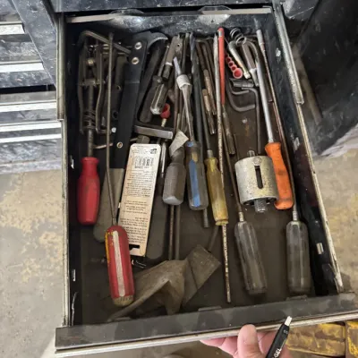 Sale Photo Thumbnail #86: Open metal toolbox drawer filled with assortment of hand tools including screwdrivers, Allen wrenches, and specialty mechanical tools.