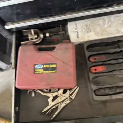 Sale Photo Thumbnail #76: Tool chest drawer containing a red STD locking lug nut remover kit, various locking pliers, a puller tool, and a tray of hand tools.