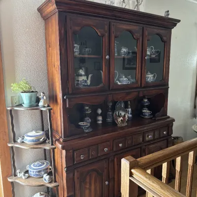 Sale Photo Thumbnail #43: Large wooden hutch filled with blue and white porcelain china, positioned next to a matching tiered corner shelf.