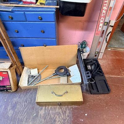 Collection of vintage tools including a Craftsman electric drill in its original box, a metal toolbox, and power tool accessories...