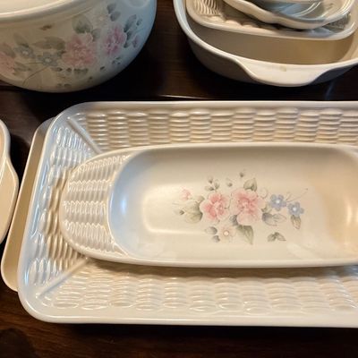 Collection of Pfaltzgraff Tea Rose pattern ceramic serveware, including platters, bowls, and a pitcher featuring a basketweave texture...
