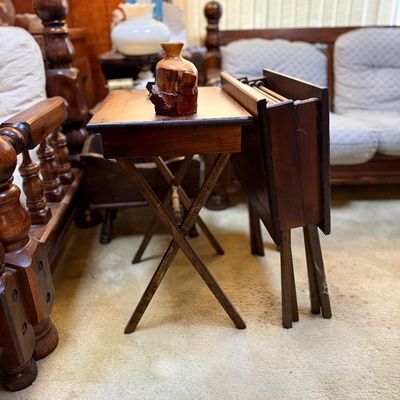 Set of vintage dark wood folding TV tray tables with a matching storage rack stand, featuring an open table with a live-edge wooden...