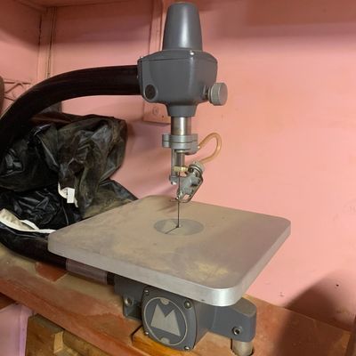 Vintage Shopsmith scroll saw attachment mounted on a wooden base with attached dust collection hose.