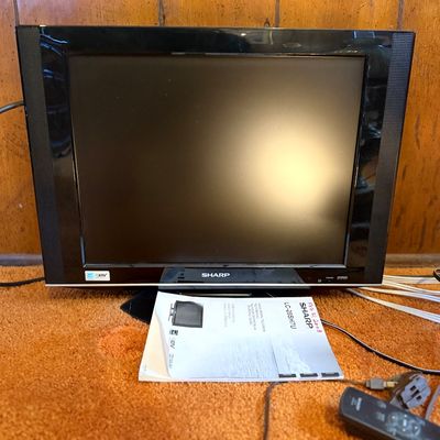 Sharp AQUOS LC-20SH7U liquid crystal television in black, complete with original user manual dated 2008 and remote control.