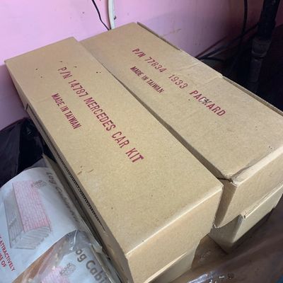 Vintage model car kits in original cardboard packaging, including a Mercedes car kit and a 1933 Packard kit, both made in Taiwan.
