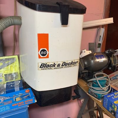 Vintage Black & Decker central vacuum power unit mounted on a wall, showing light wear.
