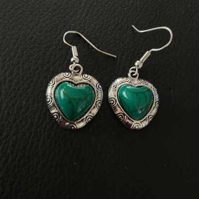 Sale Photo Thumbnail #127: Pair of silver-tone dangle earrings featuring heart-shaped charms with ornate scrollwork borders and marbled green stone or resin cabochon centers. Equipped with French wire fishhook ear wires. The heart charms measure approximately 0.75 inches long. Pre-