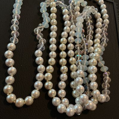 Sale Photo Thumbnail #205: A long vintage beaded strand featuring cream-colored faux pearls alternating with faceted iridescent crystal glass beads and pale blue faceted glass beads. The strand appears continuous/flapper style without a clasp. Shows light vintage wear appropriate f