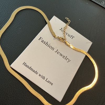 Sale Photo Thumbnail #187: Joycuff fashion jewelry gold-tone herringbone flat snake chain necklace with an adjustable extender chain and lobster claw clasp. Presented on original card backing. Appears to be in unused condition with no visible wear.