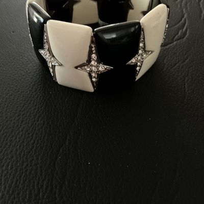Sale Photo Thumbnail #121: Bold Art Deco style stretch cuff bracelet featuring alternating black and off-white enamel tiles accented with rhinestone-paved four-point stars. Meant to slide easily over the wrist. Measures approximately 2 inches wide. Shows minor surface wear, overall