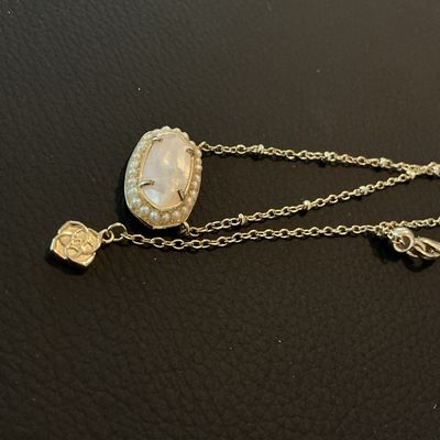 Sale Photo Thumbnail #177: Authentic Kendra Scott gold-tone pendant necklace featuring an oval iridescent Mother of Pearl style stone surrounded by a delicate seed pearl trim. Features the signature Kendra Scott filigree backing design, lobster clasp, and logo tag. In overall very 
