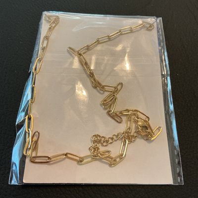 Sale Photo Thumbnail #191: Joycuff gold-tone fashion necklace featuring a rectangular pendant with the initial 'M' on a paperclip style chain. New in original plastic packaging with card insert.