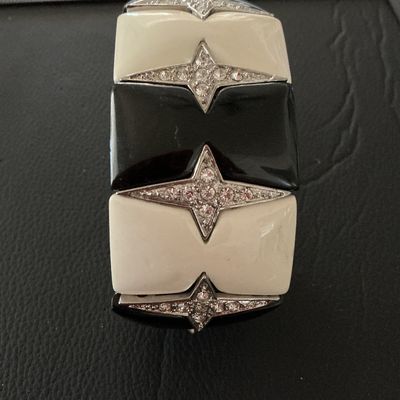 Sale Photo Thumbnail #122: Bold Art Deco style stretch cuff bracelet featuring alternating black and off-white enamel tiles accented with rhinestone-paved four-point stars. Meant to slide easily over the wrist. Measures approximately 2 inches wide. Shows minor surface wear, overall