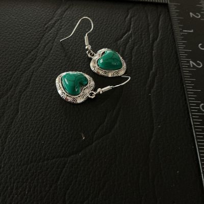 Sale Photo Thumbnail #128: Pair of silver-tone dangle earrings featuring heart-shaped charms with ornate scrollwork borders and marbled green stone or resin cabochon centers. Equipped with French wire fishhook ear wires. The heart charms measure approximately 0.75 inches long. Pre-