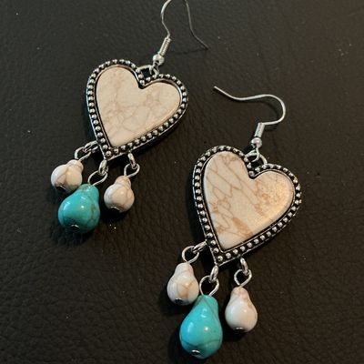 Sale Photo Thumbnail #167: Pair of Southwestern/Western style dangle hook earrings featuring heart-shaped central pendants with faux white/brown marble stone centers, textured silver-tone beaded borders, and dangling white and turquoise-colored bead charms. Good condition with no v