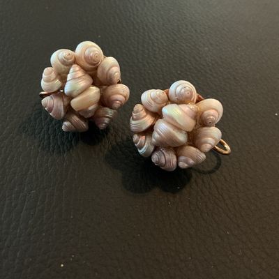 Sale Photo Thumbnail #180: Pair of vintage screw-back cluster earrings composed of small, iridescent, pearlescent spiral sea shells mounted on a gold-tone metal backing. Each earring measures approximately 3/4 inch in diameter. Good vintage condition with intact shells and function
