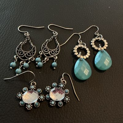 Sale Photo Thumbnail #215: A lot of three pairs of silver-tone French wire dangle earrings featuring Southwestern-inspired designs. Includes one pair of filigree chandelier earrings with turquoise-blue beads, one pair featuring faceted teal teardrops, and one pair featuring central
