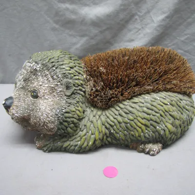 Sale Photo Thumbnail #193: Novelty hedgehog-shaped boot scraper featuring a resin body with a stiff coir bristle back.