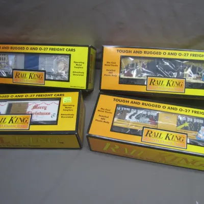 Sale Photo Thumbnail #268: Set of four RailKing by MTH Electric Trains holiday-themed O and O-27 gauge freight cars, each in original packaging.