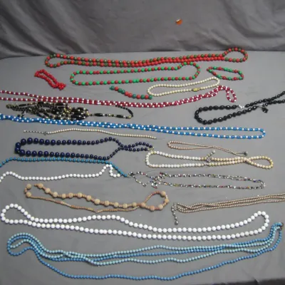Sale Photo Thumbnail #39: Large collection of vintage beaded necklaces in various colors, styles, and lengths, including faux pearl, glass, and plastic beads.