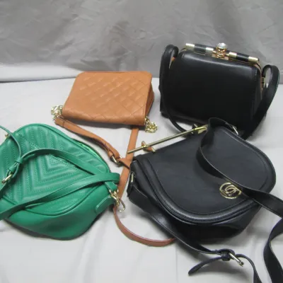 Sale Photo Thumbnail #49: Collection of four contemporary women's handbags, including a green quilted shoulder bag, a tan quilted clutch, a black frame purse, and a black Bebe cross-body bag.