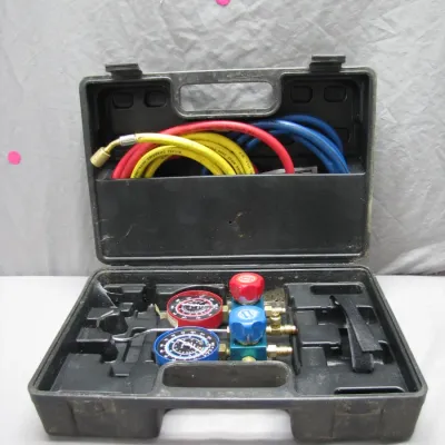 Sale Photo Thumbnail #182: A/C manifold gauge set with color-coded charging hoses, presented in a black plastic molded carrying case.