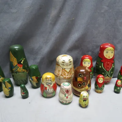 Sale Photo Thumbnail #7: Collection of vintage hand-painted wooden Russian nesting doll sets featuring bird, cat, and traditional babushka themes.