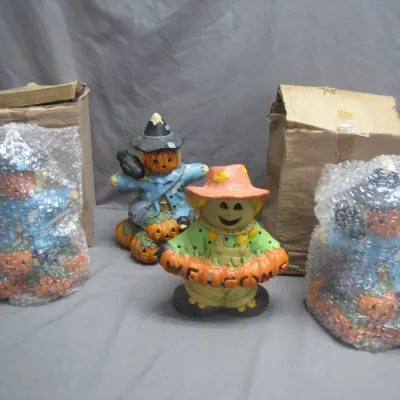 Sale Photo Thumbnail #265: Collection of four ceramic Halloween scarecrow figurines, including one with a 'WELCOME' sign and others with original boxes and bubble wrap.