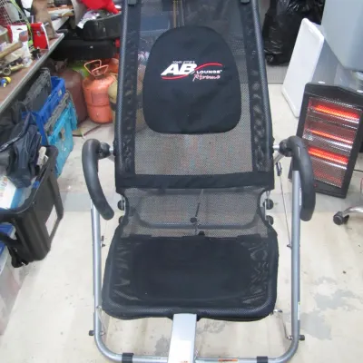 Sale Photo Thumbnail #247: Tony Little's Ab Lounge Xtreme abdominal workout chair with black mesh seating and silver metal frame, showing light wear.