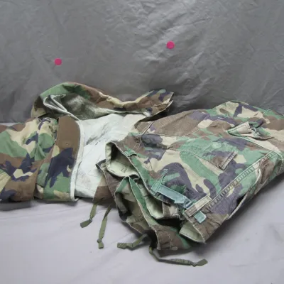 Sale Photo Thumbnail #74: U.S. military woodland camouflage jacket and trousers set, featuring ripstop fabric and adjustable tabs.