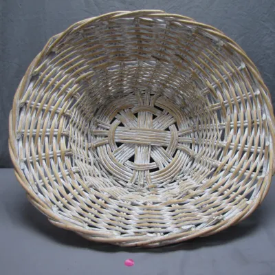 Sale Photo Thumbnail #204: Large round whitewashed wicker basket featuring a decorative spoke weave design on the bottom.