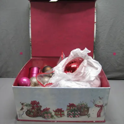 Sale Photo Thumbnail #183: Festive holiday storage box decorated with a snowman and winter scene, filled with assortment of Christmas ornaments and wrapping ribbon.