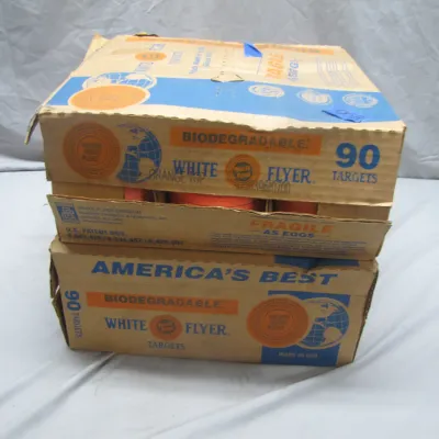 Sale Photo Thumbnail #304: Two cardboard boxes containing White Flyer biodegradable clay targets for trap and skeet shooting.