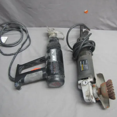Sale Photo Thumbnail #38: Pair of corded power tools, including an Ace digital heat gun and a Craftsman Industrial 4 1/2-inch angle grinder fitted with a wire cup wheel, both showing moderate signs of use.