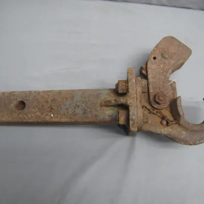 Sale Photo Thumbnail #172: Vintage heavy-duty rusted cast iron pintle hook hitch attachment.