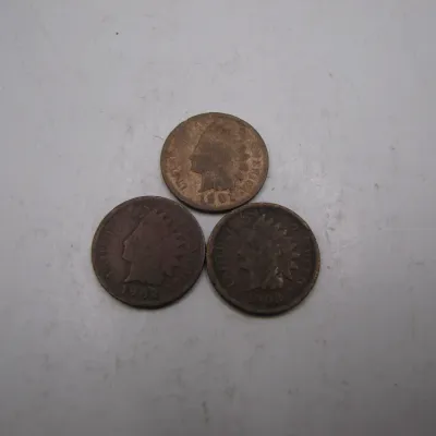 Sale Photo Thumbnail #20: Trio of antique US Indian Head cent coins, including dates from the early 1900s, showing typical circulation wear.